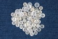 Plastic shiny buttons for clothes on a fabric background. Fashion and clothing. Factory industry Royalty Free Stock Photo