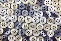 Plastic shiny buttons for clothes on a fabric background. Fashion and clothing. Factory industry Royalty Free Stock Photo