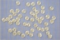 Plastic shiny buttons for clothes on a fabric background. Fashion and clothing. Factory industry Royalty Free Stock Photo