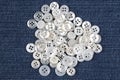 Plastic shiny buttons for clothes on a fabric background. Fashion and clothing. Factory industry Royalty Free Stock Photo