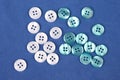 Plastic shiny buttons for clothes on a fabric background. Fashion and clothing. Factory industry Royalty Free Stock Photo