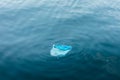 Plastic bag floating and polluting the water, sea and ocean Royalty Free Stock Photo