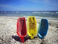 Plastic shovels on the beach. Playing in the sand. Royalty Free Stock Photo