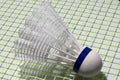 Plastic Shuttlecock of badminton put on the green net of badminton Racket. Royalty Free Stock Photo