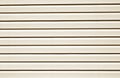Plastic siding surface in brown tone. Royalty Free Stock Photo