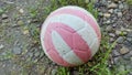 Striped soccer ball on gravel road