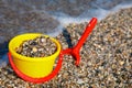 Plastic spade and bucket in sand Royalty Free Stock Photo