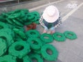 Plastic splints are used to hold flowers and workers are cleaning and installing them.