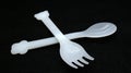 Plastic spoon and fork isolated on black background Royalty Free Stock Photo