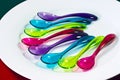 Lots of bright colourful plastic spoons. Royalty Free Stock Photo