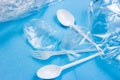 Plastic spoons, forks, bottles and cups as a disposable waste on bright blue background Royalty Free Stock Photo