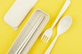 The Plastic spoons, forks and chopsticks set on yellow background Royalty Free Stock Photo