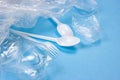 Plastic spoons, forks and cups as a disposable waste with copy space on bright blue background. Environmental pollution and litter Royalty Free Stock Photo