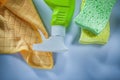 Plastic sprayer washing sponge cloth on white surface Royalty Free Stock Photo