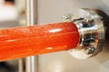 Plastic and stainless industrial pipework with a red fluid