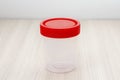 Plastic sterile container for collecting urine. Close-up, soft focus