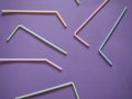 Plastic straws pattern on purple