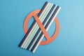 Plastic straws used for drinking water or soft drinks. concept of protest on blue background. No Plastic. Royalty Free Stock Photo