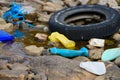 Plastic and styrofoam pollution from ocean on beach. Dirty spilled garbage waste