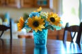 plastic sunflower centerpiece in a blue plastic vase on dining table Royalty Free Stock Photo