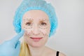 Facial plastic surgery or facelift, facelift, face correction. A plastic surgeon examines a patient before plastic surgery