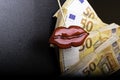 red lips on euro banknote, on black, lips plastic surgery
