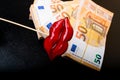 red lips on euro banknote, on black, lips plastic surgery