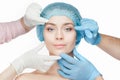 Plastic surgery concept. Doctor hands in gloves touching woman face