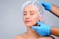 Plastic surgery. Woman with perforation lines on the face. Anti-aging treatment and face lift Royalty Free Stock Photo