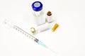 Plastic syringe put in a medical needle and vial bottles with 3 ml. ampule is opened isolate on white background