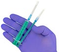 Plastic syringes and needle in hand in medical glove Royalty Free Stock Photo