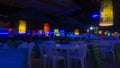 Plastic tables in a disco bar with blue lights near the beach