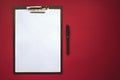 Plastic tablet with white sheet of paper on the red Background. Top View. Concept of new opportunities, ideas, undertakings, Royalty Free Stock Photo