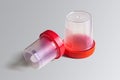 Plastic test jars with red lids on a light background Royalty Free Stock Photo