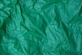 Plastic texture of a piece of crumpled green cellophane