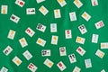 Plastic tiles from the game rummikub, rummy or  okey in Turkey , scattered and arranged on  green Royalty Free Stock Photo