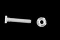 Plastic toilet screw on black isolated background Royalty Free Stock Photo