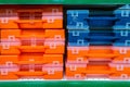 Plastic tool boxes on store shelves. Stack of organizers