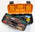 A plastic toolbox with full of dirty, rusty, dusty, used tools