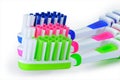 Green, blue and pink toothbrushes are isolated on a white Royalty Free Stock Photo