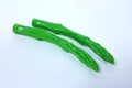 Plastic toy asparagus And a white backdrop Royalty Free Stock Photo