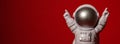 Plastic toy astronaut on colorful red background Copy space. Concept of out of earth travel, private spaceman commercial