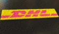 Plastic toy blocks compose logo of DHL, editorial conceptual 3d rendering