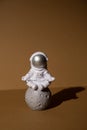 Plastic toy figure astronaut on beige neutral background Copy space. Concept of out of earth travel, private spaceman