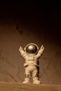 Plastic toy figure astronaut on moon concrete background Copy space. Concept of out of earth travel, private spaceman