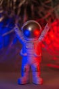 Plastic toy figure astronaut with red and blue light Copy space. Concept of out of earth travel, private spaceman