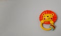 plastic toy in the form of a lion cub with a handle on a gray background Royalty Free Stock Photo