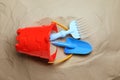 Plastic toy set with shovel on sand, flat lay Royalty Free Stock Photo