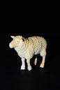 Plastic toy sheep on a black background. Realistic toy Copy Space Royalty Free Stock Photo