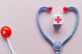 Plastic Toy Stethoscope and red cross medical sign